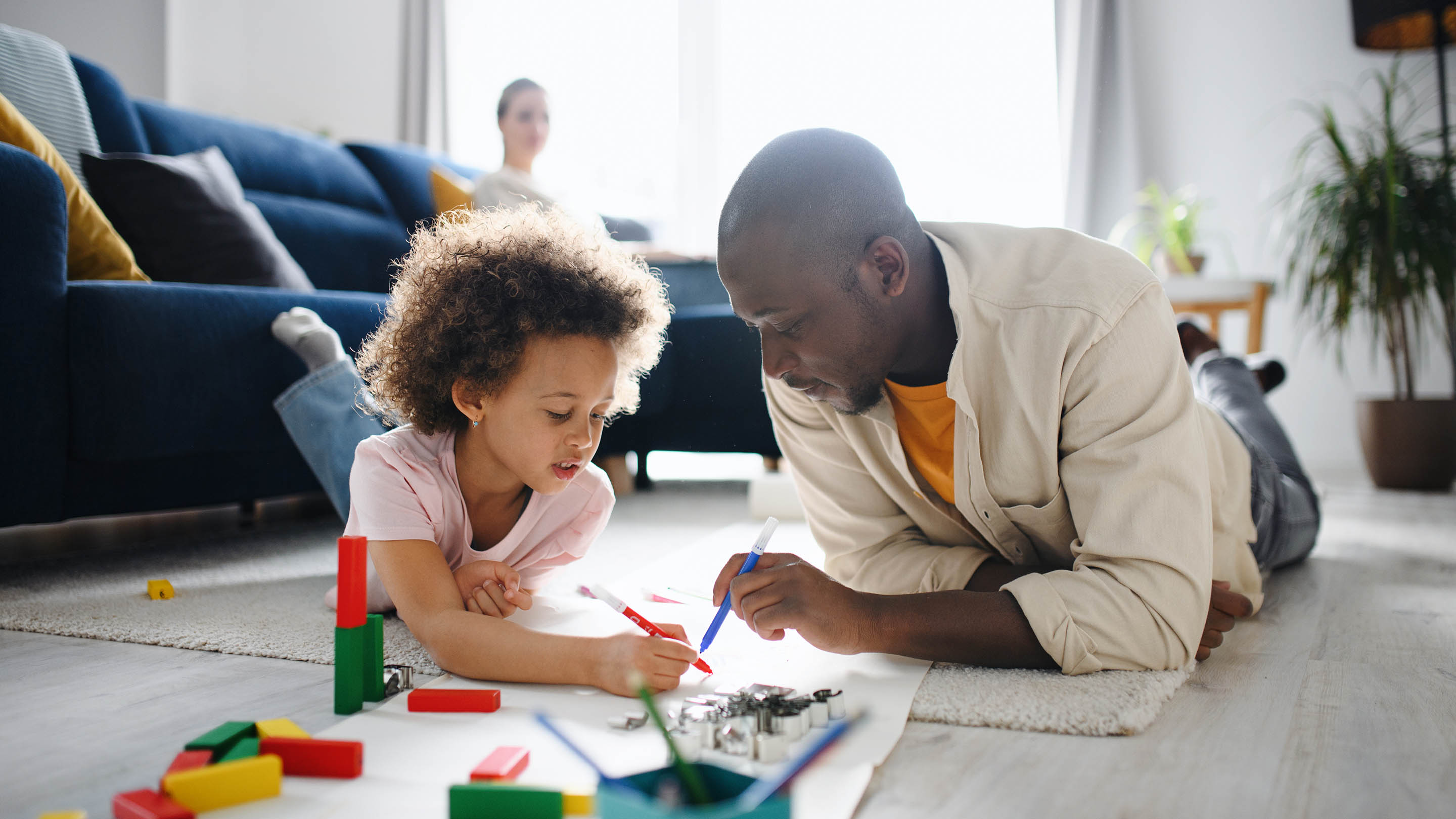 Father and daughter drawing together